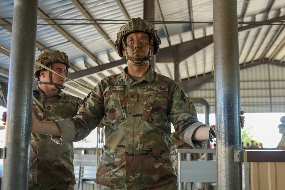 Jumpmaster goes through mock door training for prejump readiness