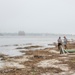 A shoreline assessment team surveys the beach