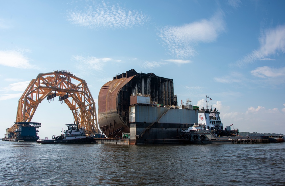 Tugs position a dry-dock barge