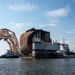 Tugs position a dry-dock barge