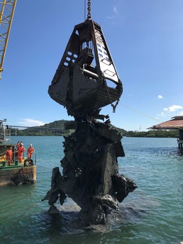 A Floating Crane Grabs Wreckage During Salvage Operations