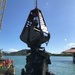 A Floating Crane Grabs Wreckage During Salvage Operations