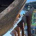 A welder cuts notches to accommodate the support stanchions
