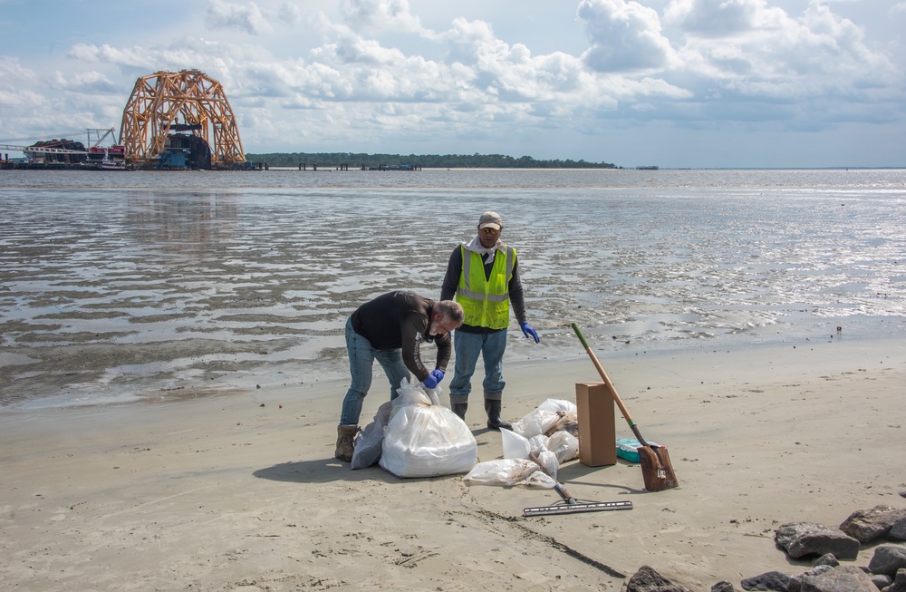 A shoreline clean up team recovers freshly deposited oil