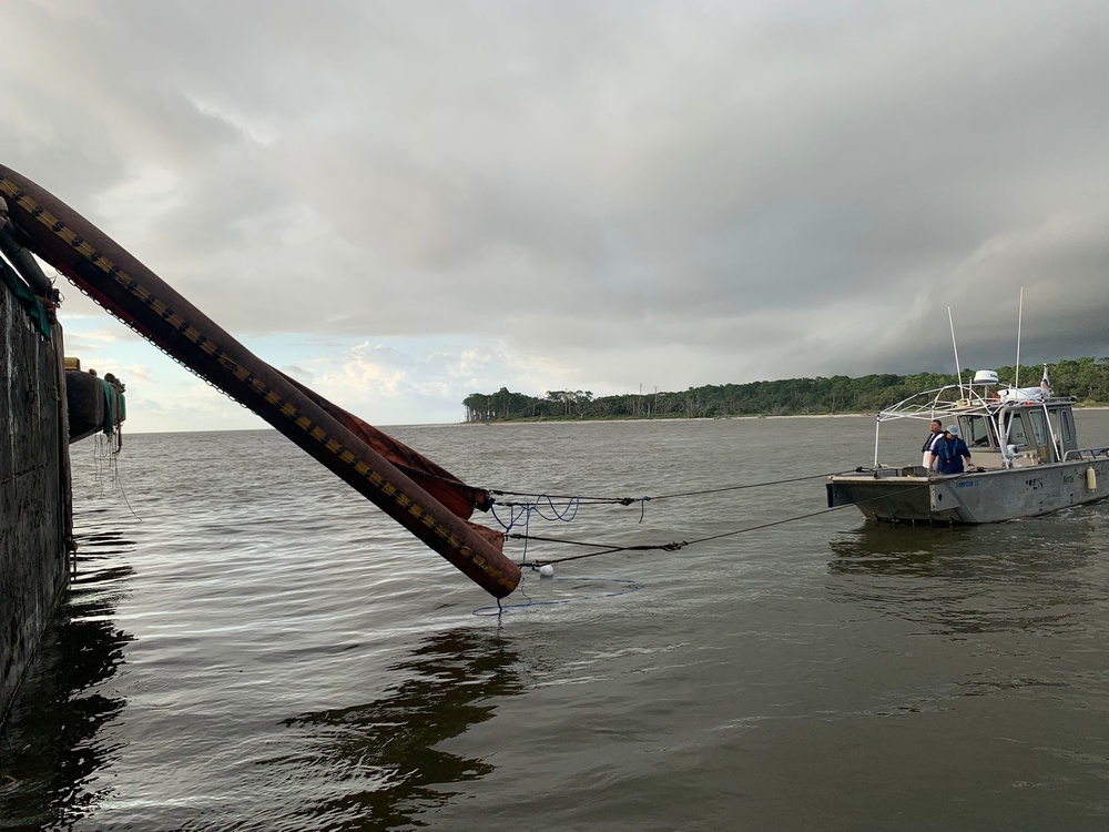 A pollution response team deploys a Current Buster