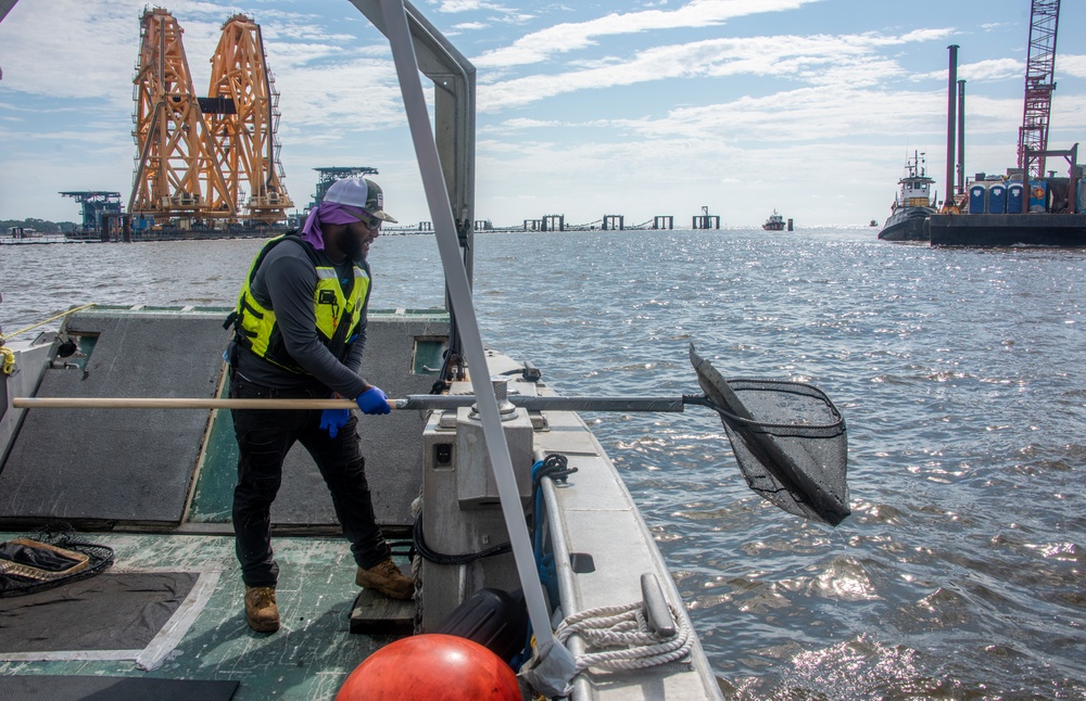 A responder recovers a piece of debris