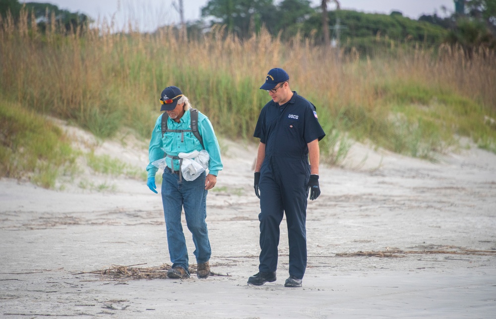 An assessment team scans the shoreline