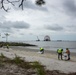 A shoreline clean-up team removes oiled sand