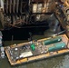 An oil recovery team pumps out oil