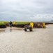 A shoreline clean-up team applies another treatment of sphagnum moss