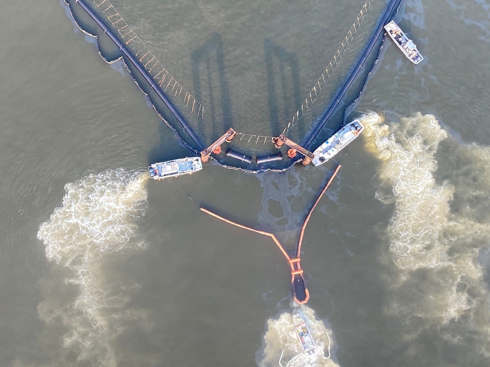 Two response vessels hold a Current Buster at an apex of the EPB