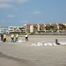 A shoreline clean-up team fills bags of oiled sand