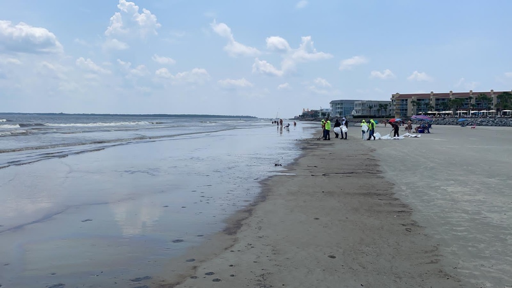 A shoreline clean-up team removes oil