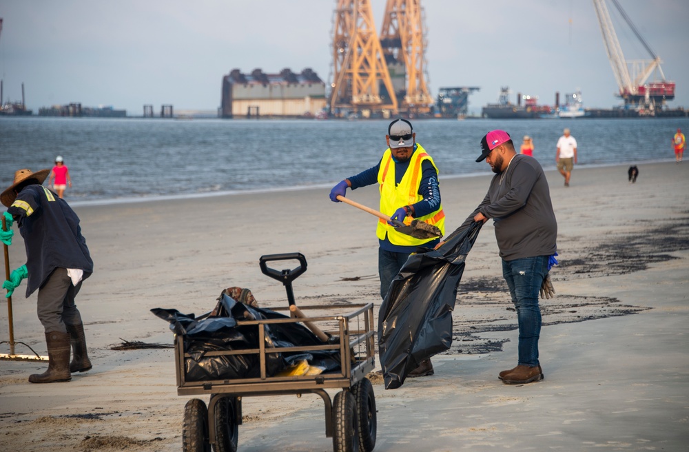 A shoreline clean-up team removes oil