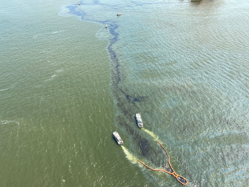 Response vessels are directed by helicopter to precisely collect oil