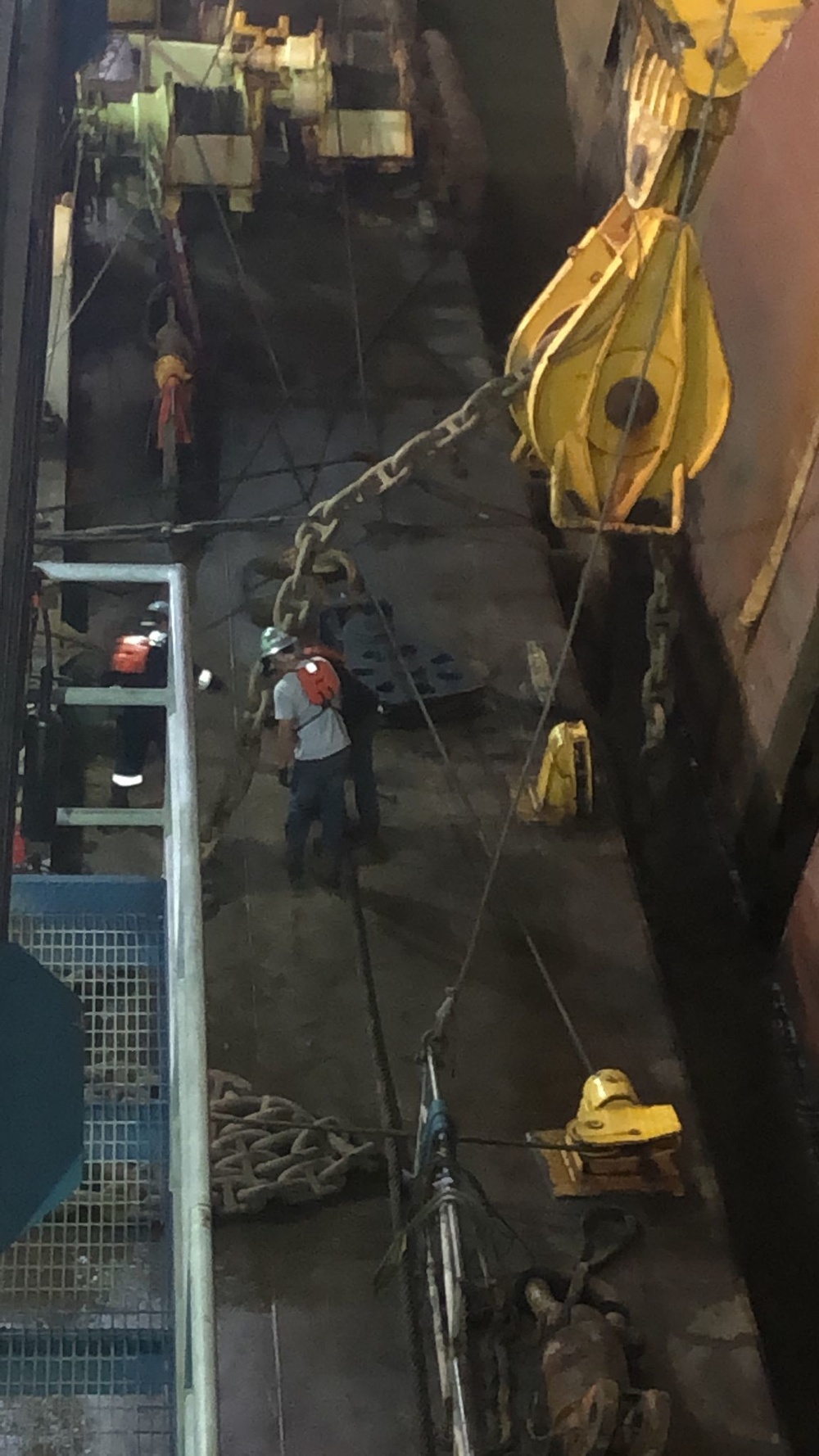 Wreck removal personnel cycle the cutting chain into a pre-cut groove