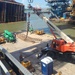 A crane operator hoists anchor chain