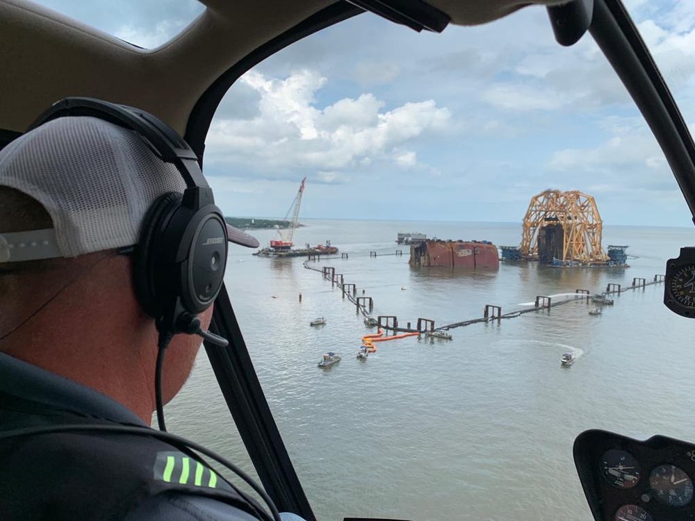 An aerial observer surveys the Golden Ray wreck site