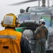SN John Lopez Signals an MH-60R Helicopter aboard the USS Dewey