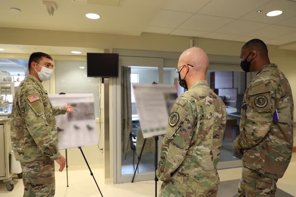 Soldiers from the 121st Field Hospital receives guidance from the DHA leadership