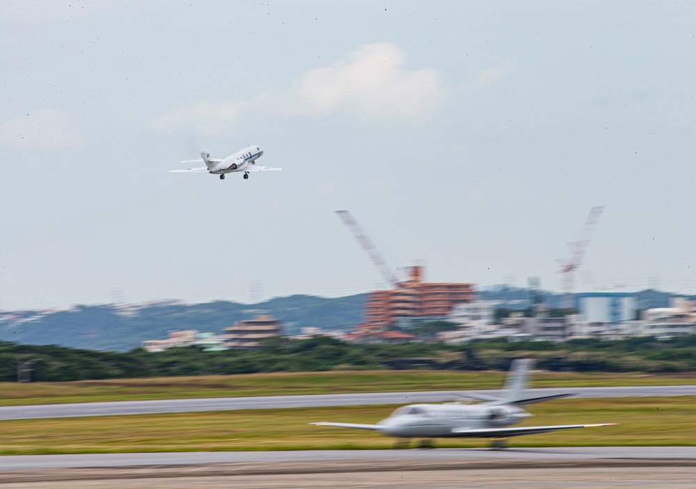 UN Command-Rear representatives and members of the French Navy observe takeoff and landing of the Falcon F200