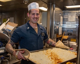 CS1 Bennett Evans Cooks in the Galley aboard USS Dewey