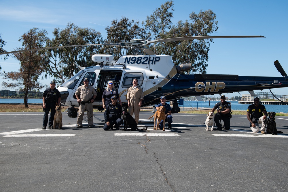 A Coast Guard member and local partner agencies pose for group photo