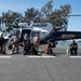 A Coast Guard member and local partner agencies pose for group photo