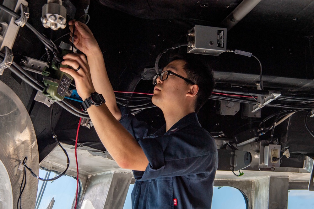 USS Charleston Sailor Conducts Maintenance on GPS