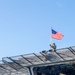 USS Charleston Sailor Observes Morning Colors