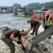 US Navy Seabees with NMCB-5 work with KBR contractors to support Harbor Operations onboard Naval Support Facility Diego Garcia