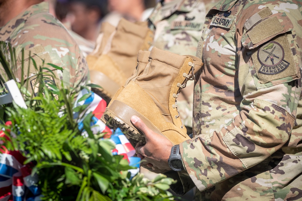 Soldier holding boots before performing Soldiers Cross