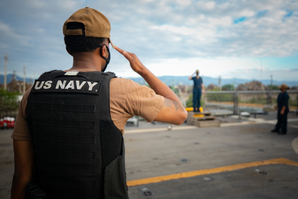 USS Sioux City Sailor Renders a Salute While Standing Watch