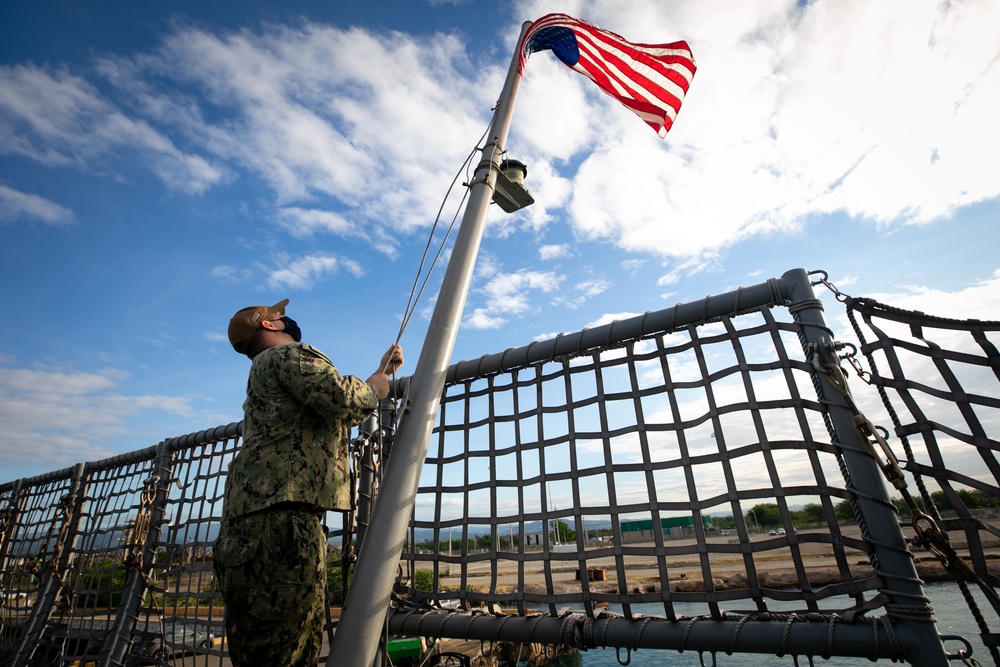 USS Sioux City Sailor Hoists the Ensign During Morning Colors