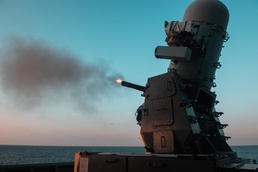 The forward-deployed amphibious assault ship USS America (LHA 6) fires its Phalanx Close-In Weapons System.