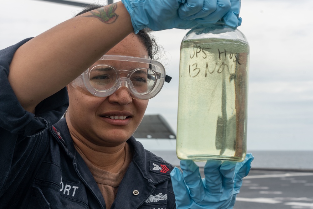 USS Jackson (LCS 6) Sailor Examines Fuel Sample