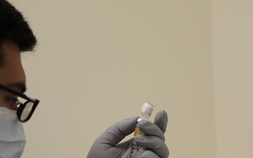 A nurse draws a pediatric COVID-19 vaccine dose