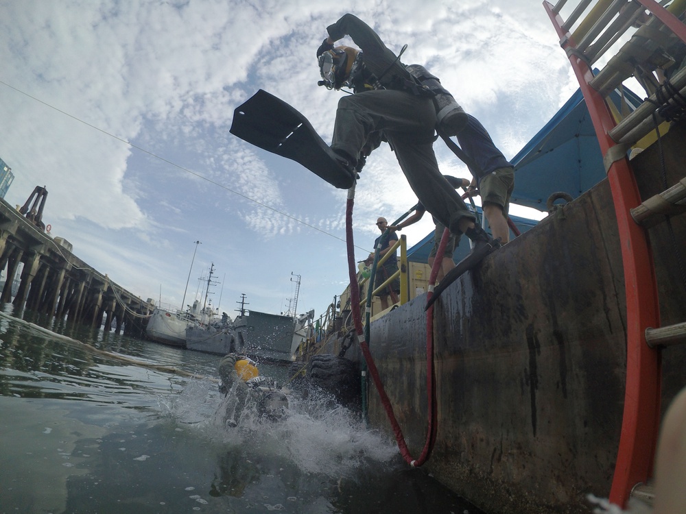 MDSU 2 Sailor Executes a Front Step Water Entry During Underwater Site Survey