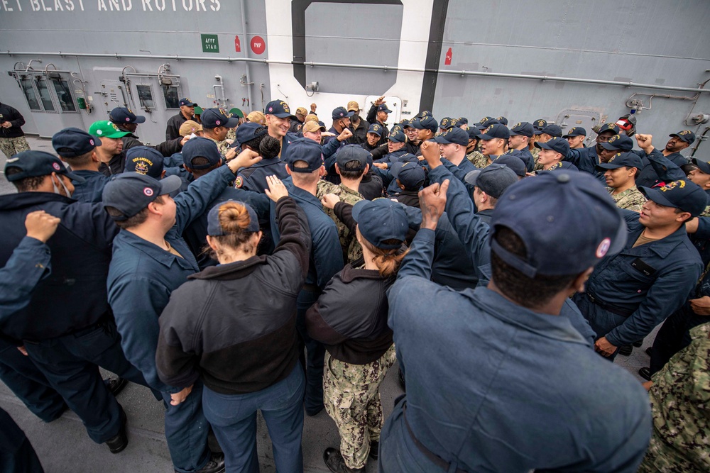 Sailors assigned to the forward-deployed amphibious assault ship USS America (LHA 6) prepare to participate in a firefighting drill on the ship’s flight deck.
