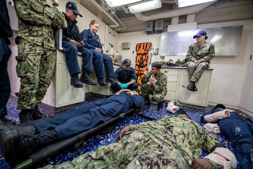 Sailors assigned to the forward-deployed amphibious assault ship USS America (LHA 6) participate in a Medical Training environment.
