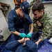 Sailors assigned to the forward-deployed amphibious assault ship USS America (LHA 6) participate in a Medical Training environment.