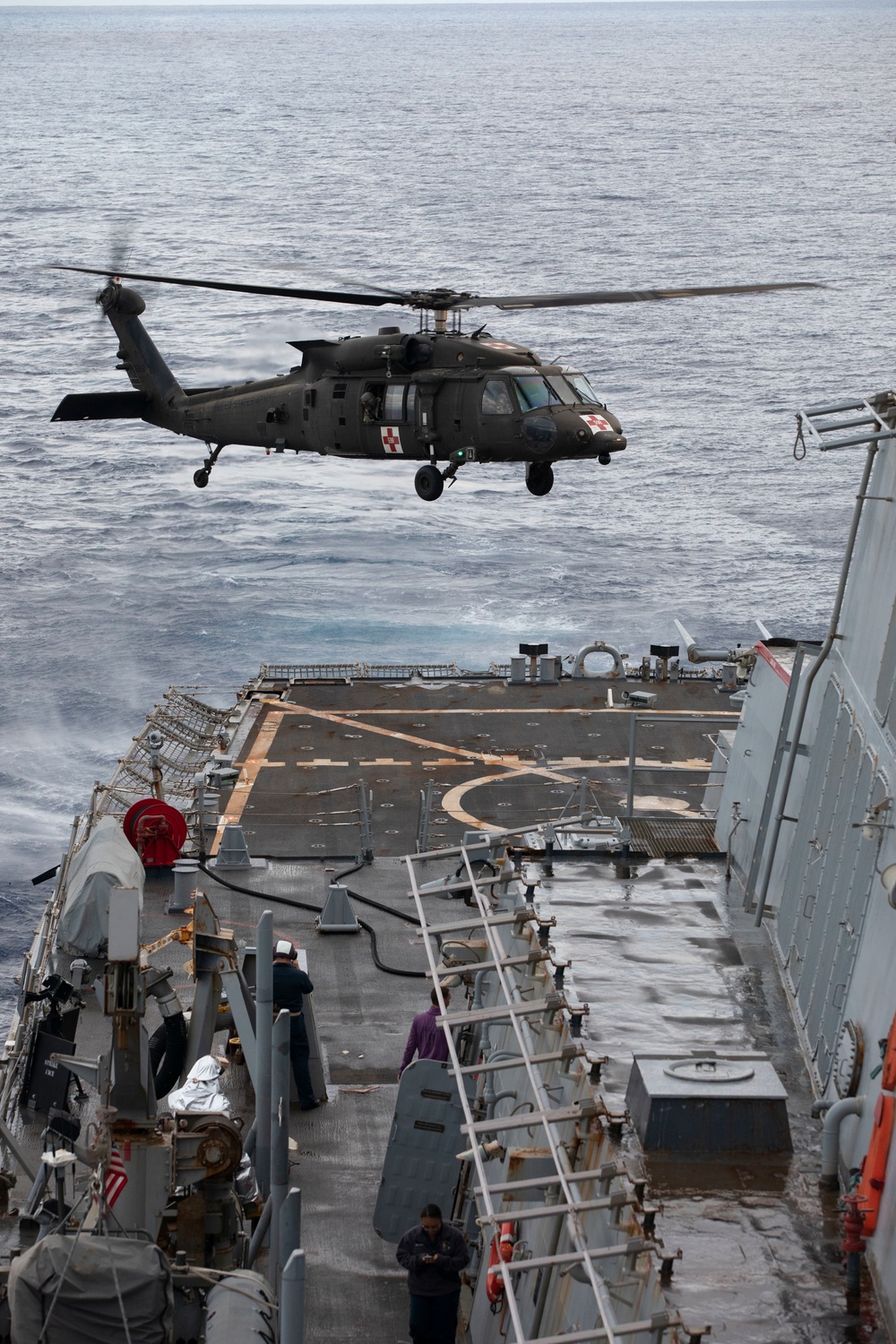 US Army UH-60 Blackhawks perform deck landing qualifications aboard USS John Paul Jones