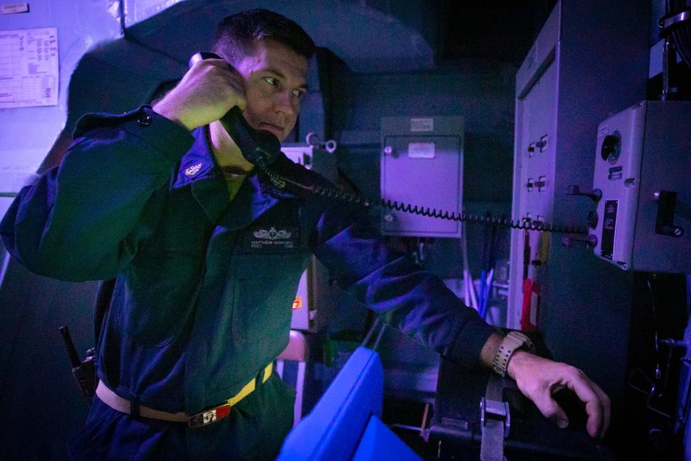 USS Sioux City Sailor Uses Sound Powered Telephone During C-ISR Drill