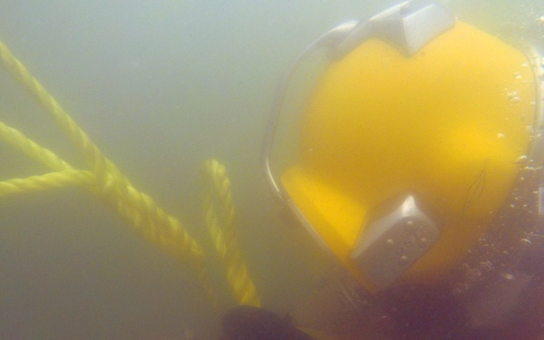 MDSU 2 Sailor Ties a Line to a Hose After Dredging Ops