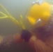 MDSU 2 Sailor Ties a Line to a Hose After Dredging Ops