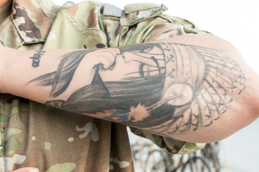 Soldier showing tattoo