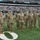 New York Jets Salute to Service Game 11/14/21 A group of approximately 10 U.S. Army soldiers in Operational Camouflage Pattern (OCP) uniforms stand at attention on the field of MetLife Stadium during a New York Jets vs. Buffalo Bills NFL game. The soldiers appear to be participating in a military appreciation ceremony on the sideline. The stadium is partially filled with spectators and the scoreboard is visible in the background.