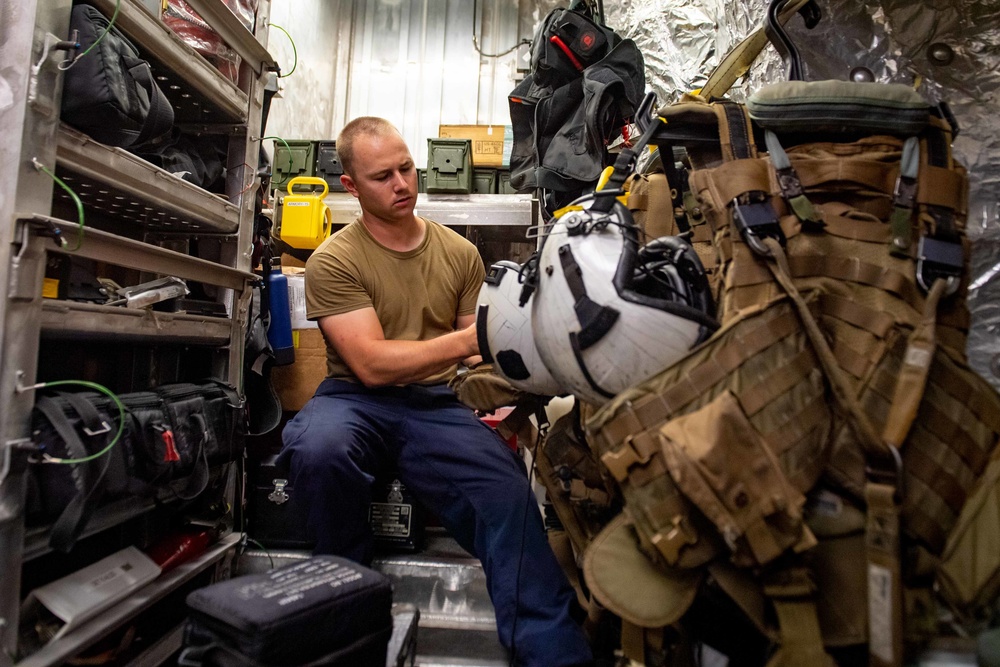 USS Charleston Sailor Conducts Inspection on Aircrew Survival Equipment