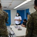 Airmen and Mañe'lu children decorate boxes for OCD