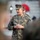 A U.S. Marines officer wearing MARPAT digital camouflage uniform is speaking to a group, with hands clasped together. The name tape on the uniform reads 'DONOVAN' and the branch tape reads 'U.S. MARINES'. The setting appears to be an outdoor military ceremony or briefing.